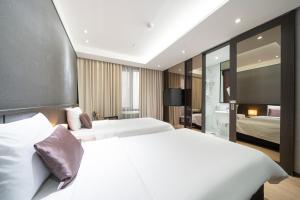 Postel nebo postele na pokoji v ubytování Ramada by Wyndham Yongin + 37 fotografií