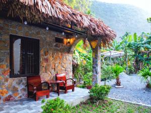 a stone house with a table and chairs outside at Cozy Beer Garden Homestay in Ninh Binh