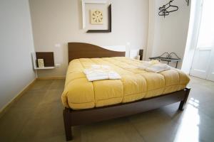 Postel nebo postele na pokoji v ubytování Rizzi Residence