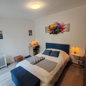 a bedroom with a large bed and a couch at Le patio Aristide in Champigny-sur-Marne