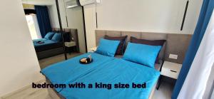 a bedroom with a king size bed with a blue sheet at Private fenced garden with BBQ area minutes from the beach - Urban Secret Kantrida in Rijeka