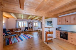 a kitchen and living room with wooden ceilings at Ferien beim Baur in Bad Bayersoien