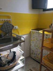 a kitchen with a shelf with pots and pans at La casa al teatro in Catania