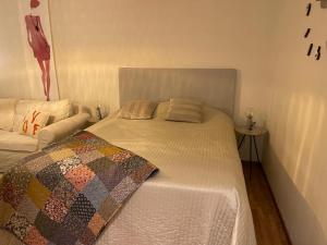 a bedroom with a bed with a quilt on it at Centrala fräscha lägenheter i Älmhult in Älmhult