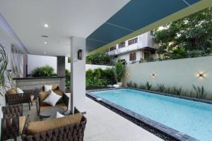 a swimming pool in the middle of a house at Aquila Hotel Bangkok in Bangkok