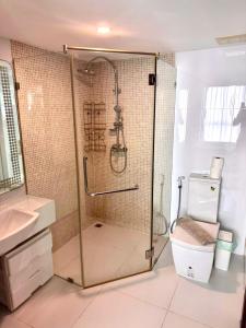 a bathroom with a shower and a toilet at Apartment Serenity Wongamat in Pattaya North