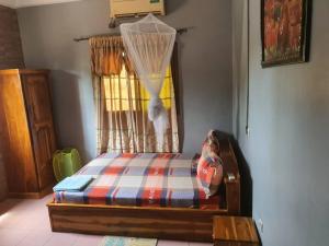a bedroom with a bed in a room with a curtain at RÉSIDENCE VICTORIA in Lomé +37 photos