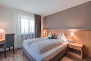 Postel nebo postele na pokoji v ubytování Hotel Reischach