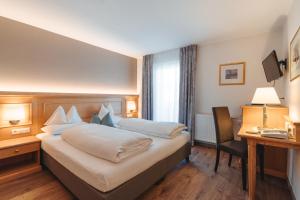 Postel nebo postele na pokoji v ubytování Hotel Reischach