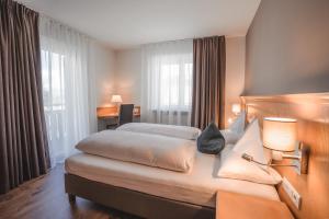 Postel nebo postele na pokoji v ubytování Hotel Reischach