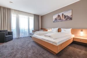 Postel nebo postele na pokoji v ubytování Hotel Reischach