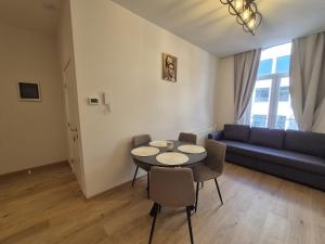 a living room with a table and a couch at Modern apartment near Avenue Louise in Brussels +6 photos