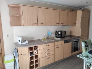 a kitchen with wooden cabinets and a sink at Quartier Torno in Torno