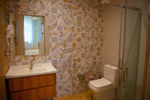 a bathroom with a sink and a toilet and a mirror at Qachaquch Forest in Qusar