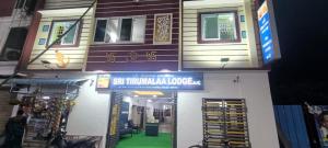 a building with a sign on the side of it at Sri Tirumalaa Hotel in Chennai