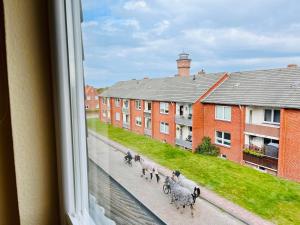 a group of animals walking down a street from a window at Ferienwohnung Janssen in Borkum