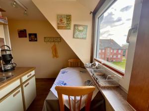 a small kitchen with a sink and a window at Ferienwohnung Janssen in Borkum