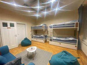 a room with three bunk beds and a couch at FG Boutique Hostel in Sarajevo