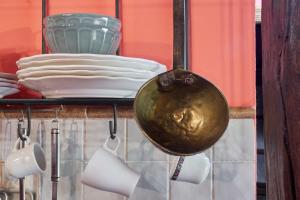 a shelf with plates and a gold vase on it at El Apartamento in Robledo de la Guzpeña +12 photos