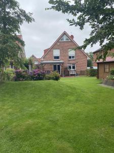 a large brick house with a green yard at Haus Petra in Borkum +42 photos