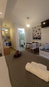 a bedroom with a large bed and a living room at Nefeli Luxury Studios in Kamena Vourla +10 photos