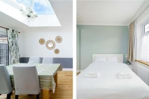 a bedroom with a bed and a dining room with a table at Stunning Family Bungalow With Private Parking in Dagenham
