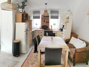 a kitchen and dining room with a table and chairs at Kö's Apartment in Jena