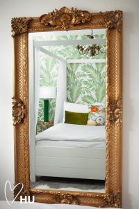 a mirror with a white bed in a room at Sky Marina Suite Penthouse in Hull +30 photos