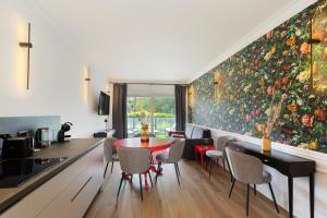 a dining room with a large painting on the wall at Sense Rooms in Baveno
