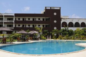 a large swimming pool in front of a building at White Peacock Resort Mtwapa in Mombasa