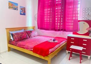 a bedroom with a bed with pink curtains and a dresser at Sulong Inn - Private Pool Homestay in Kuantan, Pantai Sepat in Kuantan +22 photos