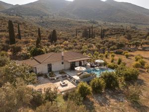 an aerial view of a house with a swimming pool at Yliessa - Luxury pool villa surrounded by nature in Dhrákas