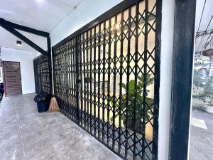 a room with a iron fence on a wall at The White Den Chatuchak in Bang O
