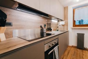 a kitchen with a sink and a counter top at Cuore Di Neve - Family Chalet in La Salle +23 photos
