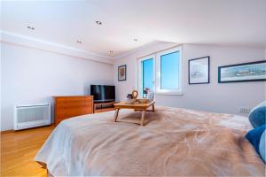 a bedroom with a large bed and a tv at Hedera Estate Villa Hedera XIX in Mlini