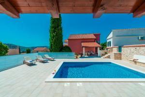 a swimming pool on a patio with a house at Hedera Estate Villa Hedera XIX in Mlini
