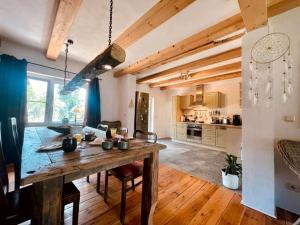 a kitchen and dining room with a wooden table at Ferienhaus am Rande des Spreewald in Heinersbrück