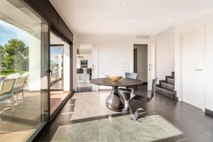 a dining room with a table and glass doors at Villa Roman in Lloret de Mar