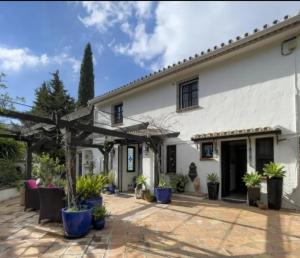 an exterior view of a white house with potted plants at Mijaa pueblo Paradise villa anex in Mijas