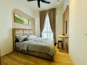 a bedroom with a bed and a ceiling fan at The Muji Glen3R2B with Netflix, 6pax YPM112 in Kuching