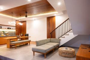 a living room with a couch and a table at Sudut Padi Villa Ubud by Omkara Experience in Ubud