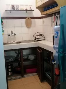 a kitchen with a sink and a counter top at Bali Budget Beach Bungalow in Candidasa