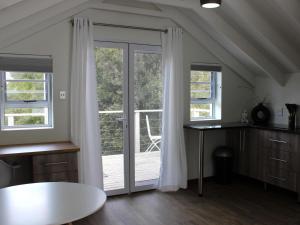 a room with a sliding glass door with a balcony at Storms River Peak Accommodation in Stormsrivier