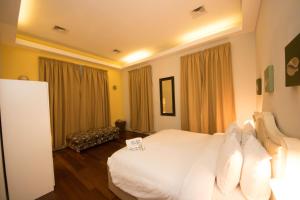 Ένα ή περισσότερα κρεβάτια σε δωμάτιο στο Olma Colonial Suites