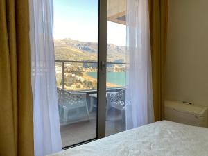 a bedroom with a view of a balcony at Harmonia Budva 1 in Budva