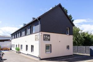 a large white building with a black roof at Ferienwohnung Freedom 2 Sky Terrasse High End in Northeim
