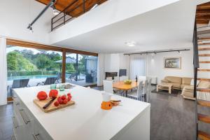 a kitchen and living room with a white counter top at Villa Terra Nera in Sveti Petar u Šumi
