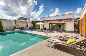 a swimming pool in the backyard of a house at Villa Terra Nera in Sveti Petar u Šumi