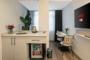 a kitchen with a fireplace in the middle of a room at The Capri Hotel Osmanbey in Istanbul