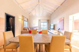 a dining room with a table and chairs at Ereza Villas Alicia in Caleta De Fuste +11 photos